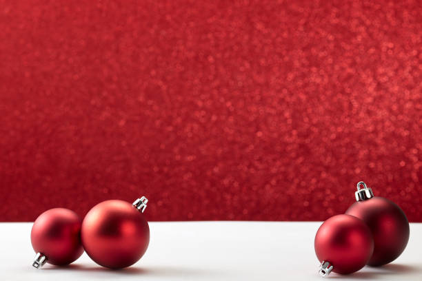 istock many christmas balls on white table red wall 1181325313
