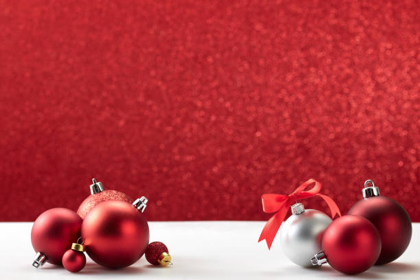 istock many christmas balls on white table red wall 1181325320