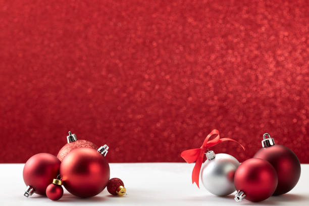 istock many christmas balls on white table red wall 1181325321