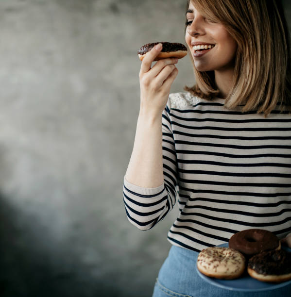 istock Woman holding donut 1181328660