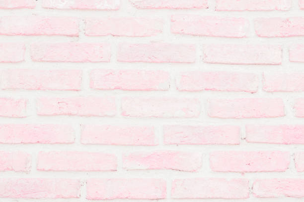 istock Pastel Pink and White brick wall texture background. Brickwork or stonework flooring interior rock old pattern clean concrete grid uneven bricks design stack. 1181329652