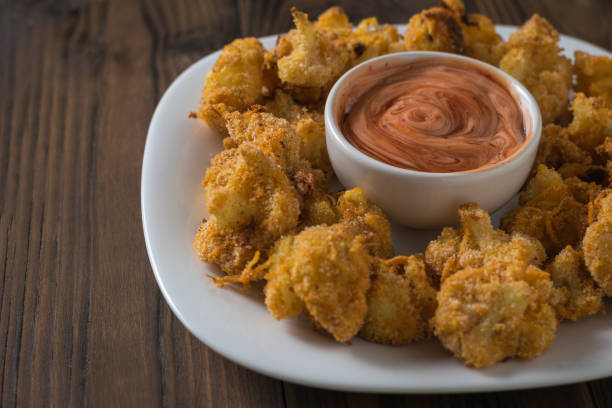 istock Cauliflower with sauce baked in batter with garlic. 1181333870