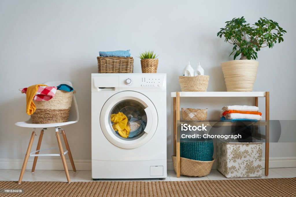 laundry room with a washing machine Interior of a real laundry room with a washing machine at home Washing Machine Stock Photo