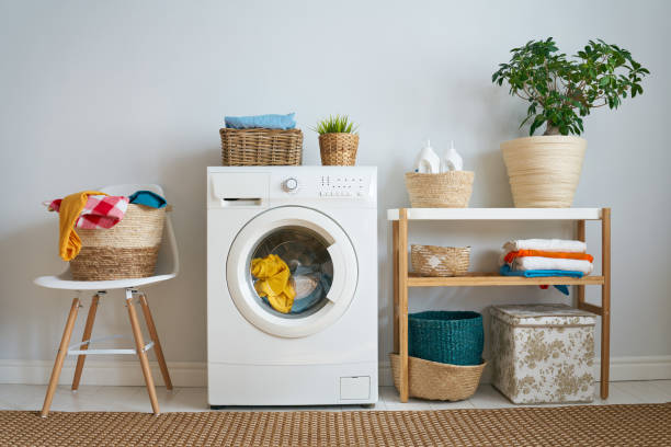 laundry room with a washing machine Interior of a real laundry room with a washing machine at home washing machine photos stock pictures, royalty-free photos & images