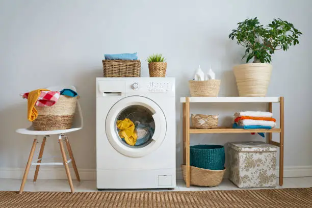 Interior of a real laundry room with a washing machine at home