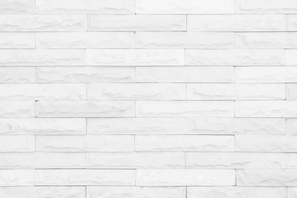 istock Seamless White pattern of decorative brick sandstone wall surface with concrete of modern style design decorative uneven have cracked realmasonry wall of multicolored stones or blocks white cement. 1181337434