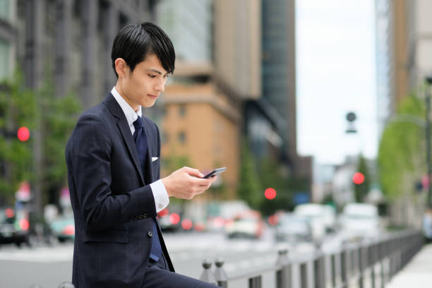 istock Young businessman using smart phone on street 1181338251