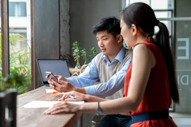 istock Two colleagues chatting in a modern office 1181338559