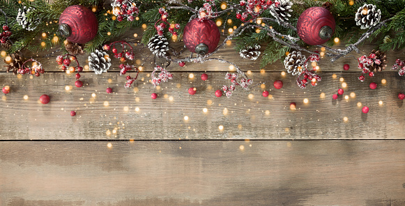 Christmas berry garland border on an old wood background
