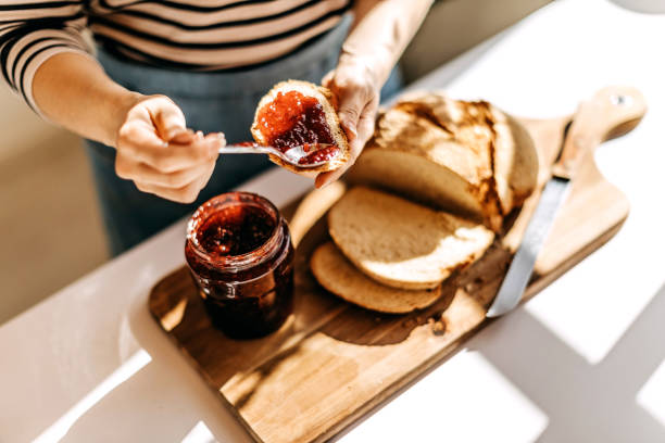 Morning routine Woman preparing breakfast jam stock pictures, royalty-free photos & images