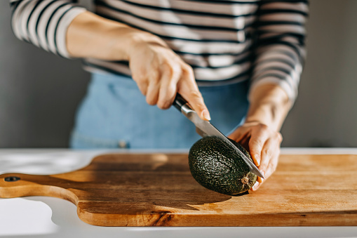 Woman cutting avocado