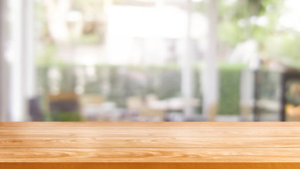 istock Wood table in blurry background of modern restaurant. 1181346652