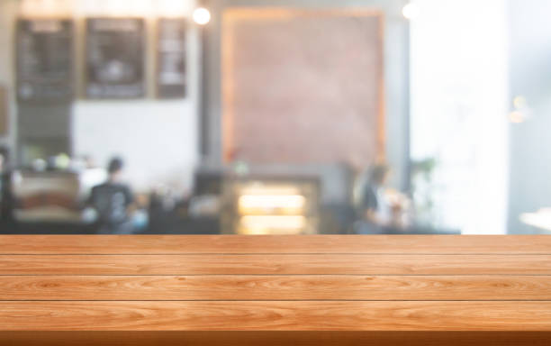 istock Wood table in blurry background of modern restaurant. 1181346674