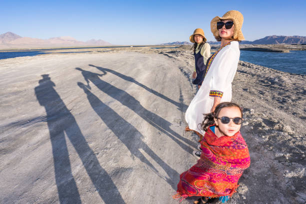 istock mother and two daughters and shadows 1181348696