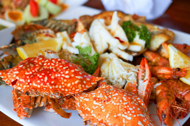 istock Sea food on big plate include shrimps ,lemon,squid and crab shell 1181349480