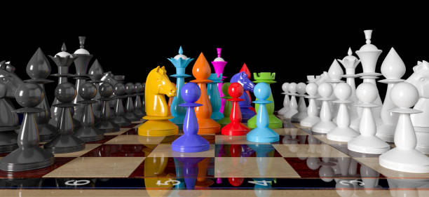 istock Colored chess. Colored chess in rainbow colors or LGBT communities stand on a chessboard between rows of white and black pieces. 1181353941