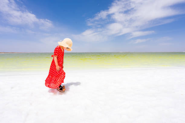 a young girl playing by the lake side