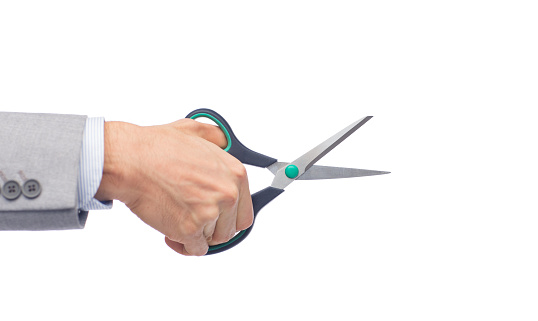 business, people, and office concept - close up of businessman hand holding scissors