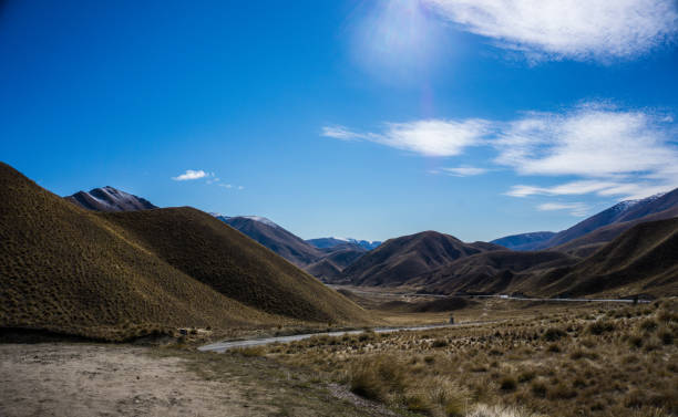 istock lindis pass landscape blue clouds New zealand 1181359873