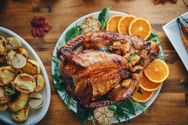istock Preparing Stuffed Turkey for Holidays in Domestic Kitchen 1181360382