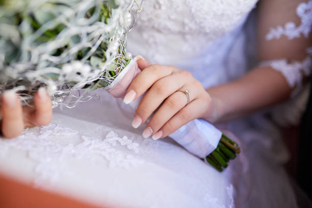 Closeup shot of a bride holding a bouquet of flowers on her wedding day