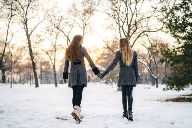 istock Two beautiful women in the snow 1181363674