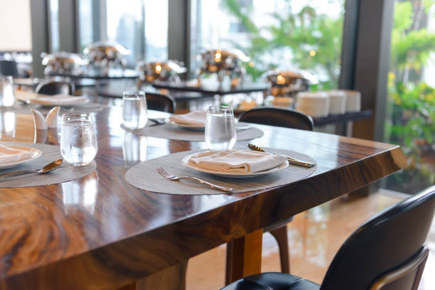 istock Tableware setting in the restaurant. Decorated elegant table, porcelain plates, glasses, napkin, knife, fork and spoon on wooden table 1181363920