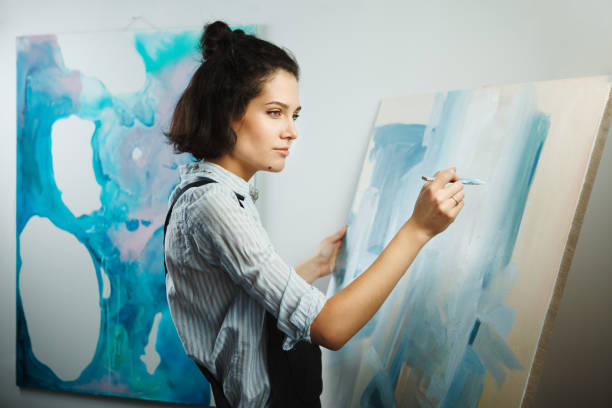 istock Concentrated woman focused on creative art-making process in art therapy 1181366655