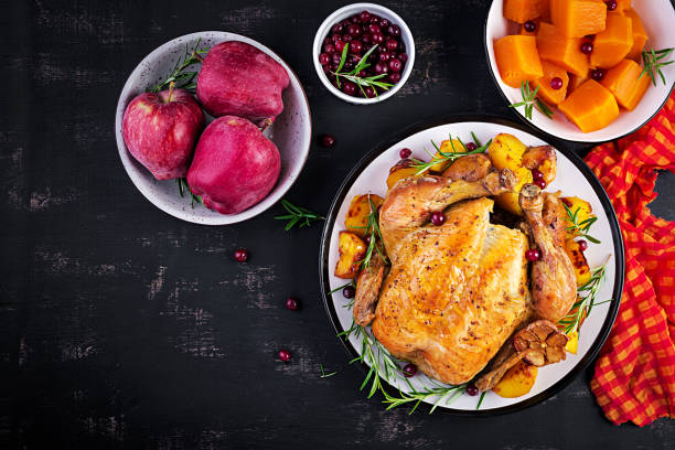 istock Roasted turkey garnished with cranberries on a rustic style table decorated  autumn leaf. Thanksgiving Day. Baked chicken. Top view 1181366890
