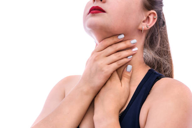 istock Woman touching her throat isolated on white 1181367968