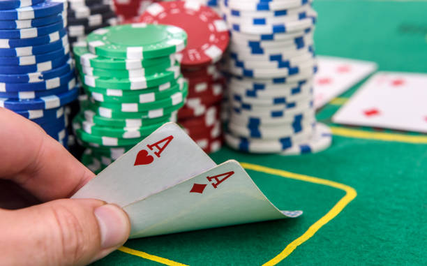 istock Winner combination. Human hand with playing cards and casino chips close up 1181368211
