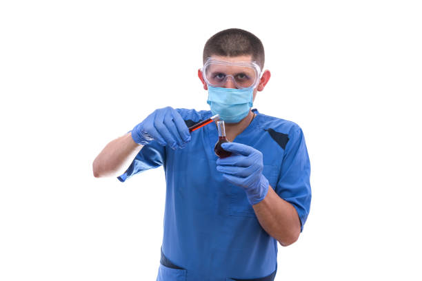 istock Chemist working with test tube. He's holding it and looking on it isolated on white 1181369053