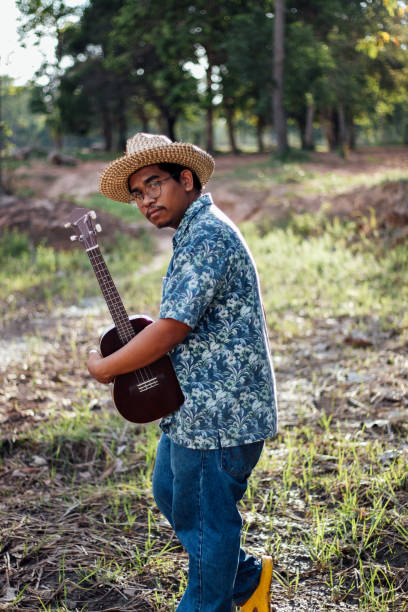 istock Happy farmer play ukulele 1181371412