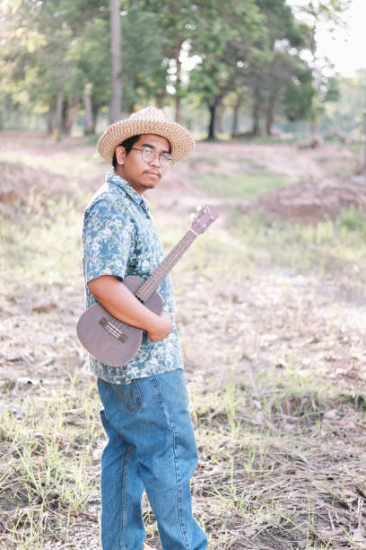 istock Happy farmer play ukulele 1181371425