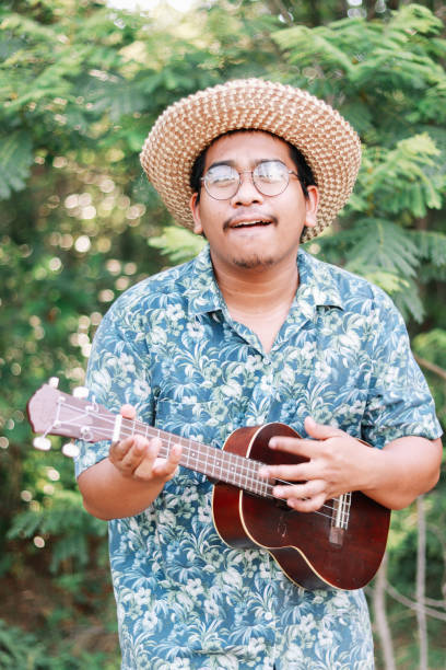istock Happy farmer play ukulele 1181371801