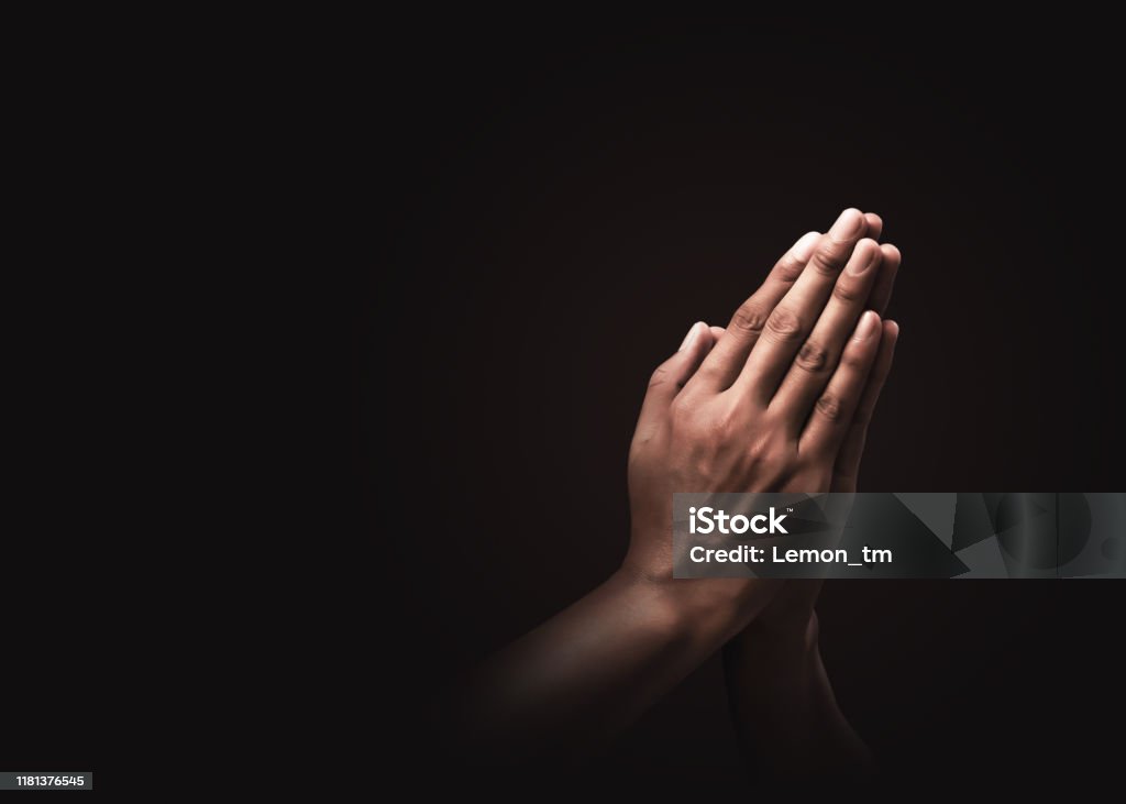 Praying hands with faith in religion and belief in God on dark background. Power of hope or love and devotion. Namaste or Namaskar hands gesture. Prayer position. Praying Stock Photo