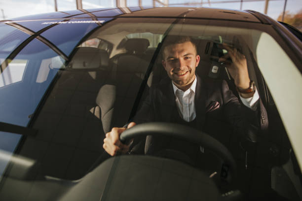 istock Hard work pays off. Young man in his new car 1181377308