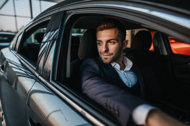 istock Confident business man looking through the window while sitting in car 1181377518