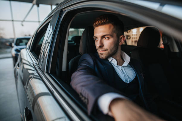 istock Confident business man looking through the window while sitting in car 1181378133