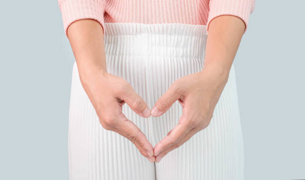 Close up view of young woman and Hand is a symbol of heart over her crotch. Feminine hygiene concept. Close up view of young woman and Hand is a symbol of heart over her crotch. Feminine hygiene concept. women private part stock pictures, royalty-free photos & images