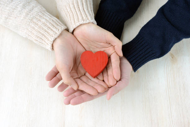 istock Man and woman's hands having heart object 1181381556