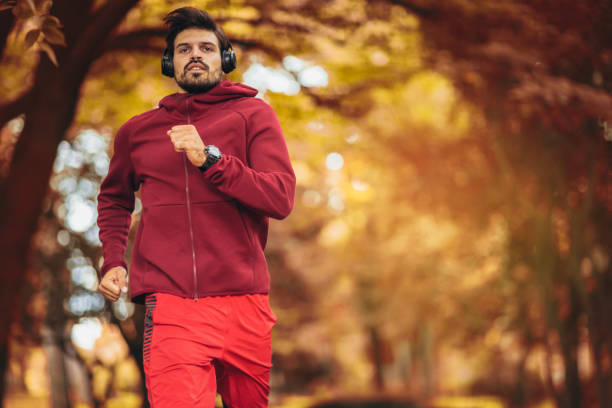 istock Young man running at park during autumn morning 1181383023