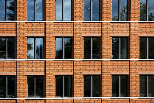 Brick facade of an contemporary office building on a sunny afternoon