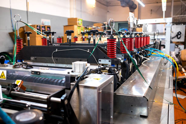 istock automatic plastic flat bottom bags making and printing  machine in modern factory, plastic packaging is mayor industrial manufacturing sector 1181383813