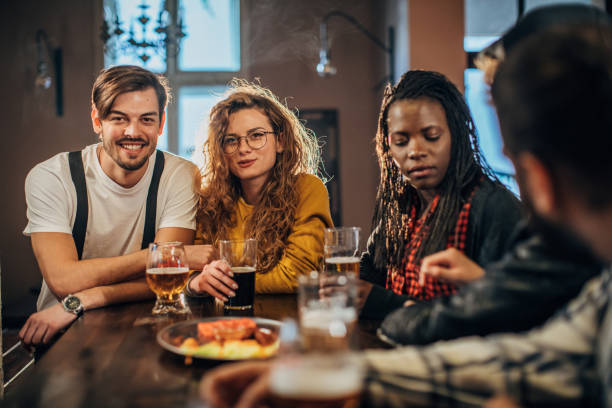 istock Friends drinking beer in bar 1181384569