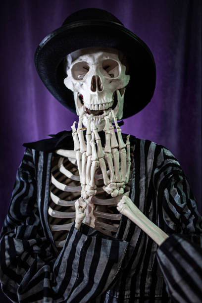 istock surprised skeleton in a striped suit and top hat. Halloween 1181386311
