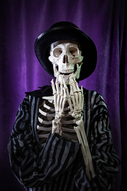 istock shocked skeleton in a striped suit and top hat. Halloween 1181386319
