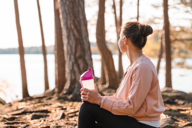 istock Woman drinking a protein shake after outdoor workout 1181386586