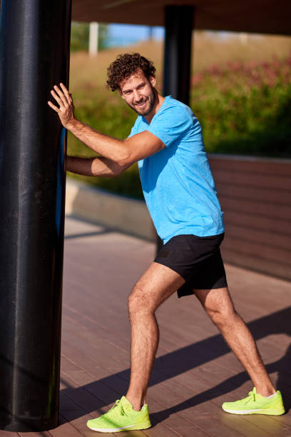 istock Man stretching and exercising in urban surroundings. 1181388962