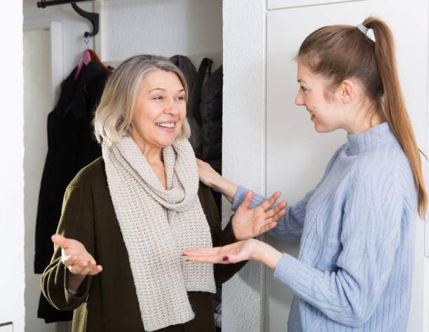 istock Two women talking  in entrance hall 1181389116